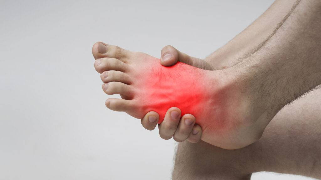 Pain in foot. Massage of male feet